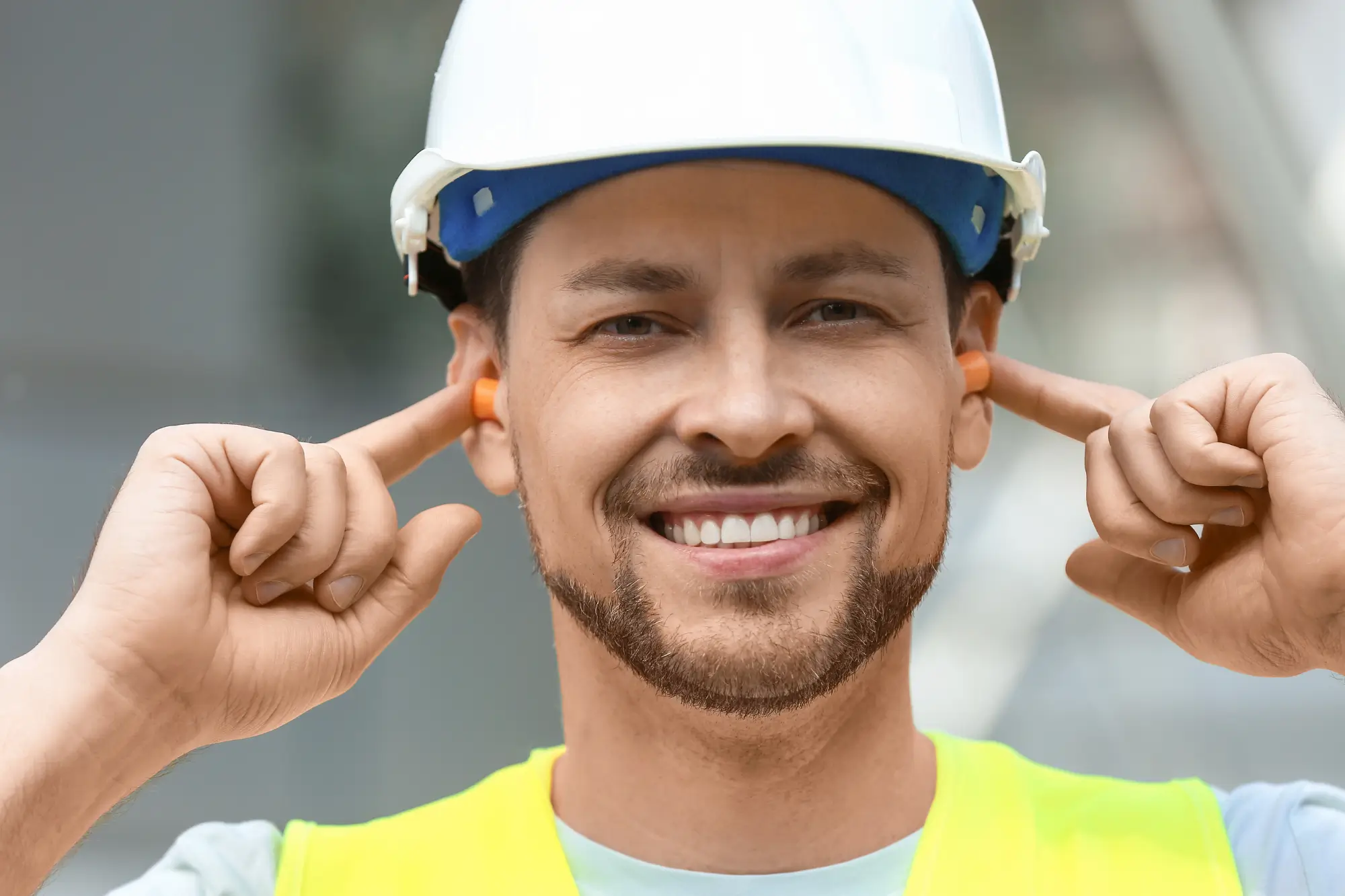 Ear plugs for work man with fingers in ear to denote he needs ear plugs, essential for ear care